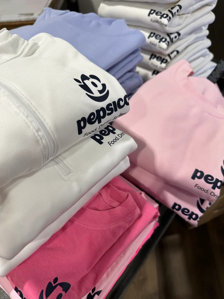 PepsiCo fleece and tees folded for kit assembly